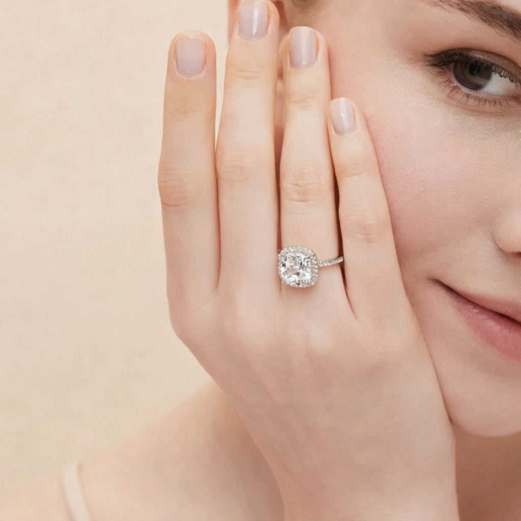 Diamond ring on a hand with a soft beige background