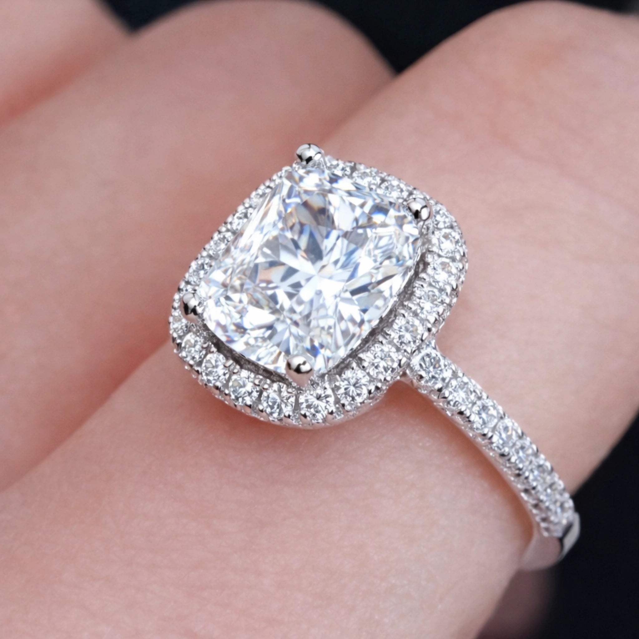 Cushion halo diamond ring close-up with brilliant sparkle and pavé band