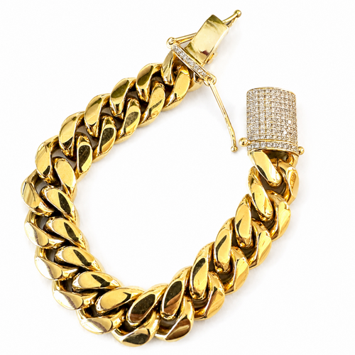 18K gold plated Cuban link bracelet on a muscular Black male wrist with an iced box clasp against a white background.